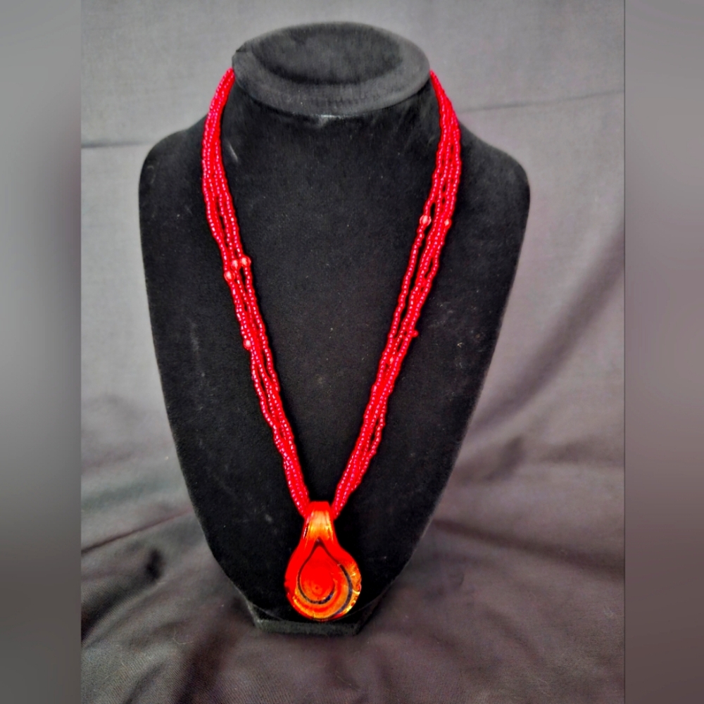 Red bead necklace with glass pendant